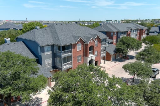 an aerial view of a row of houses with trees in the foreground at The Quarry Alamo Heights, San Antonio
