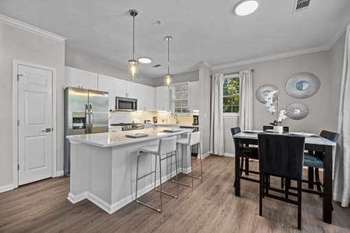 a kitchen with an island and a table with chairs