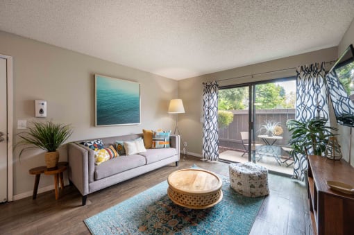 living room with couch and chair and sliding glass doors to patio