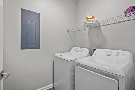 the laundry room has a washer and dryer and a door to the bathroom