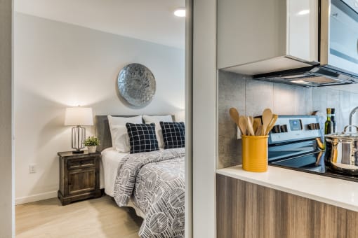 a bedroom with a bed and a stove and a window