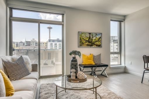 a living room with a large window and a couch and a table
