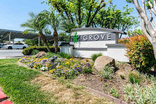 The entrance to The Grove is framed by a flower bed.