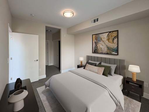 A bedroom with a large bed and a painting on the wall.