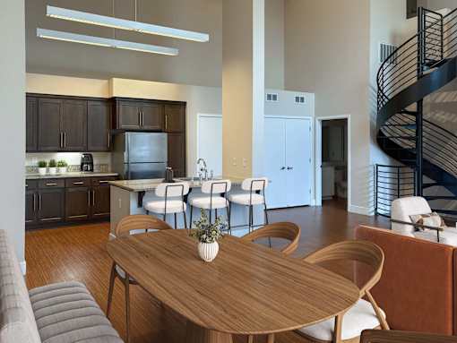 A modern kitchen with a dining table and chairs.