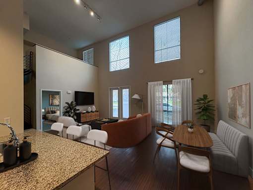 A living room with a brown table and white chairs.