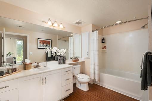 A white bathroom with a toilet, sink, and bathtub.