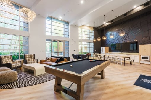 a large room with a pool table in the center of it