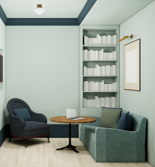 A chair with a laptop on a table in front of a wall with a shelf of books.
