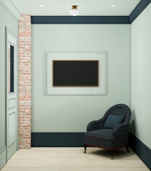 A black chair with a pillow sits in front of a brick column.