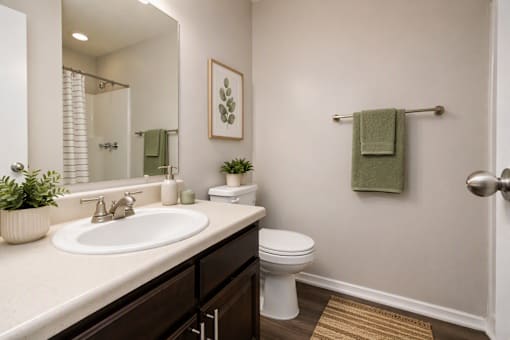 A bathroom with a white sink and toilet.