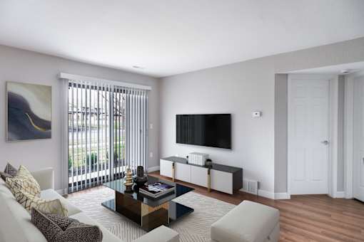 A living room with a white couch, a coffee table, and a painting on the wall.