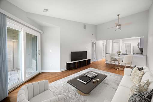 A modern living room with a white sofa and a coffee table.