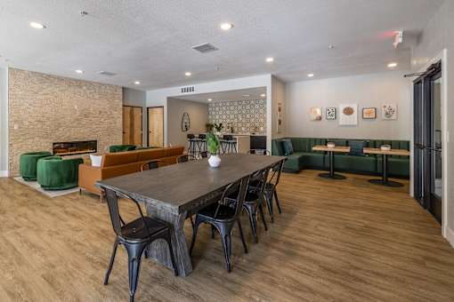 A Clubhouse With Large Table at Odyssey Apartments, New Mexico