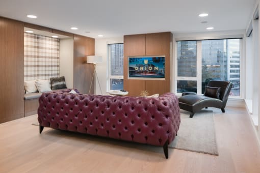 a red couch in a living room with a large window