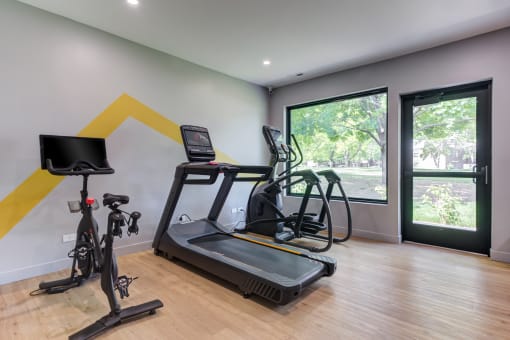 Gym with exercise equipment and a large window