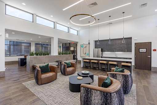 A modern office space with brown leather chairs and a wooden coffee table.