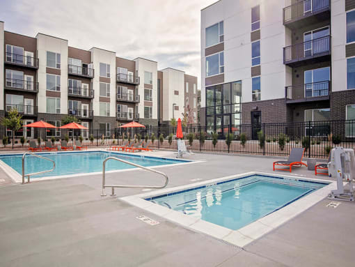 Outdoor pool and hot tub with lounge seating