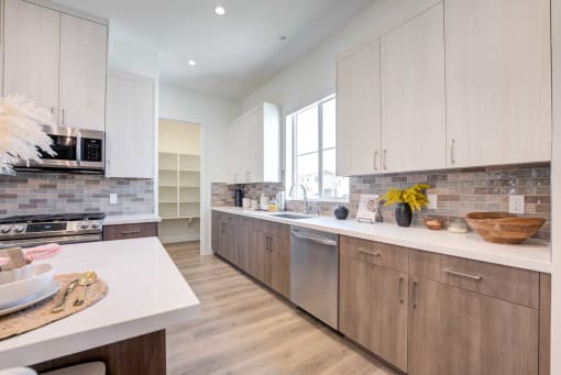 a large kitchen with wooden cabinets and white counter tops