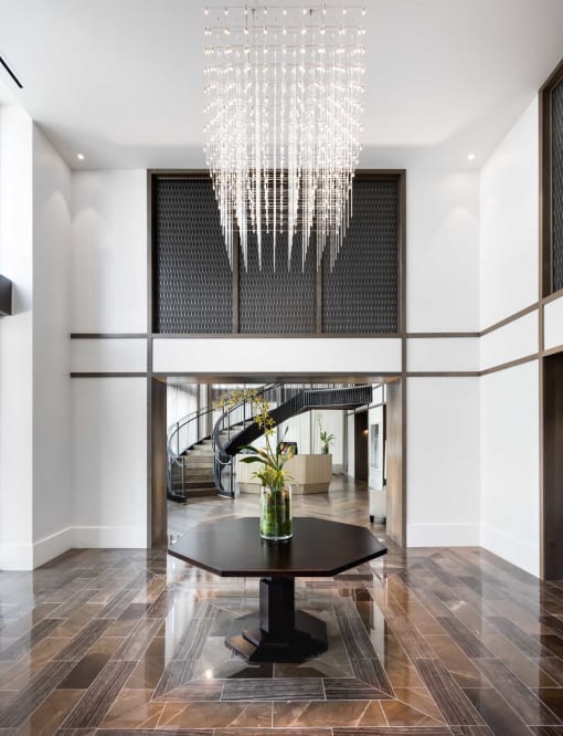 a large lobby with a table and a chandelier