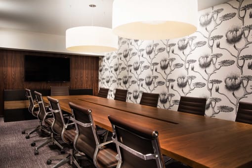 a conference room with a wooden table and chairs
