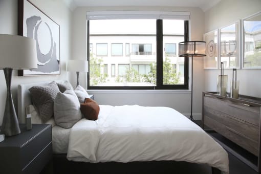 a bedroom with a large bed and a window