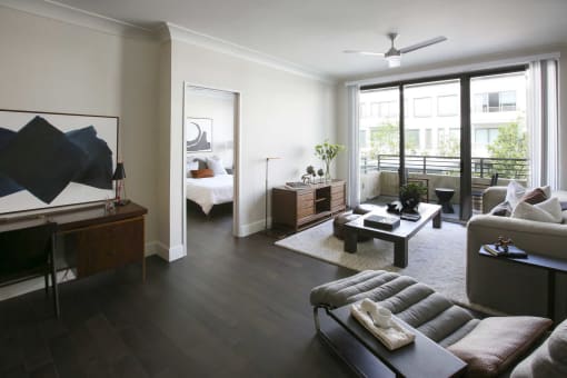 a living room with a couch and a table   and a bedroom