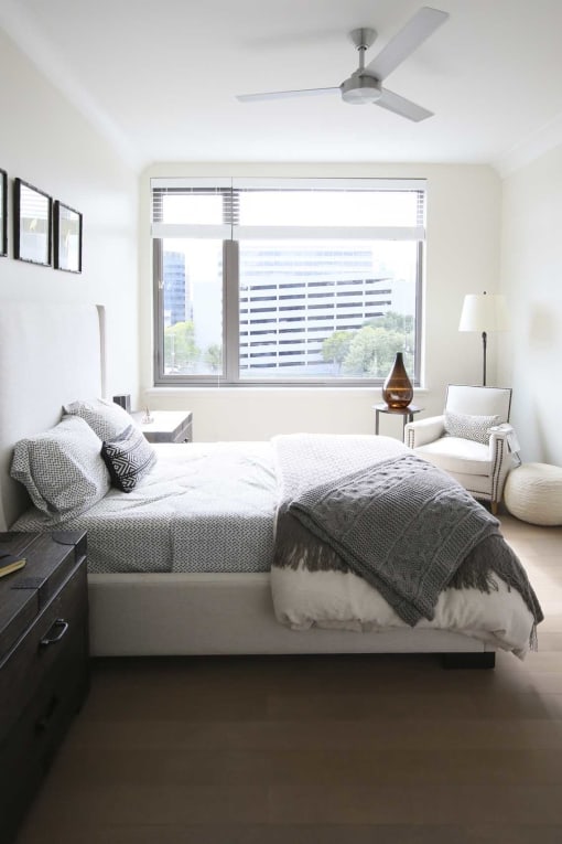 a bedroom with a bed and a window