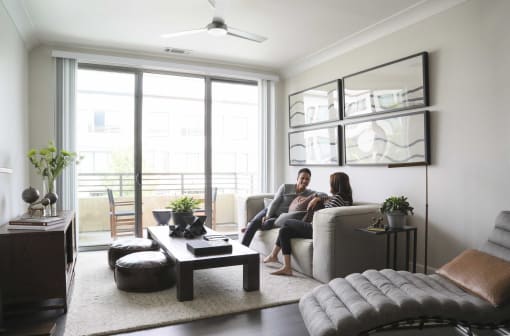 a man and woman sitting on a couch in a living room