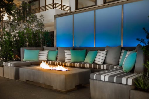 a seating area with couches and a fire pit
