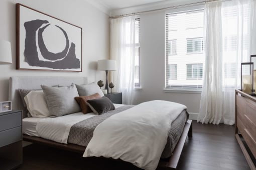 a bedroom with a bed and a painting on the wall