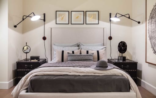 a bedroom with a bed and pictures on the wall