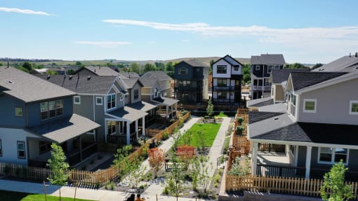 an aerial view of a row of houses and a green yard