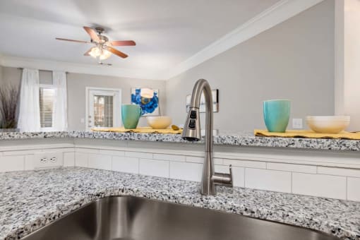 a kitchen with granite counter tops and a sink