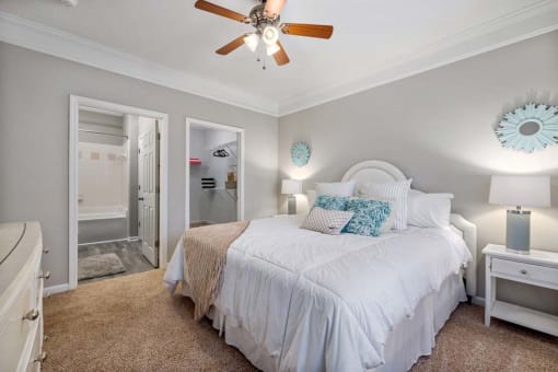 a bedroom with a large bed and a ceiling fan