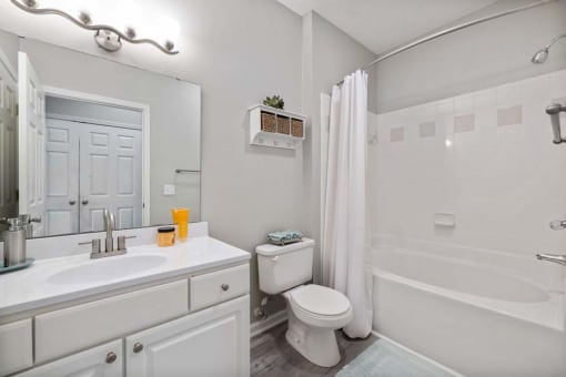 a white bathroom with a toilet and a sink