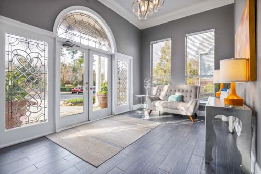 a living room with glass doors and a couch