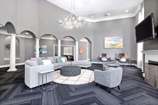 a living room with couches and chairs and a tv
