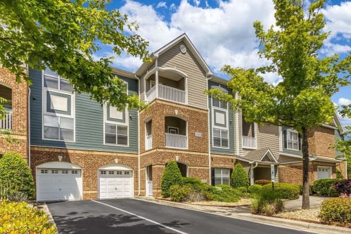 a brick apartment building with two garage doors