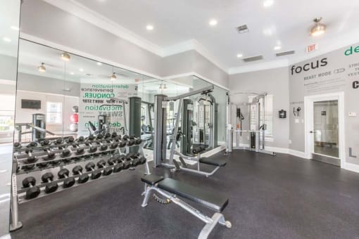 a fitness room with a lot of weights in it
