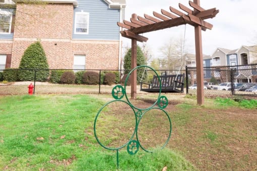 a metal sculpture in the yard of a house
