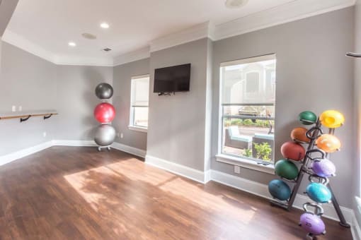 a workout room with a yoga ball tower and a window