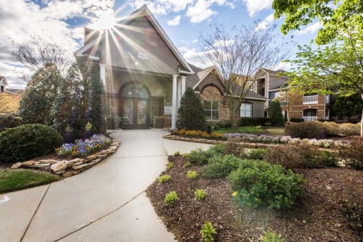 the front of a house with a sidewalk and landscaping