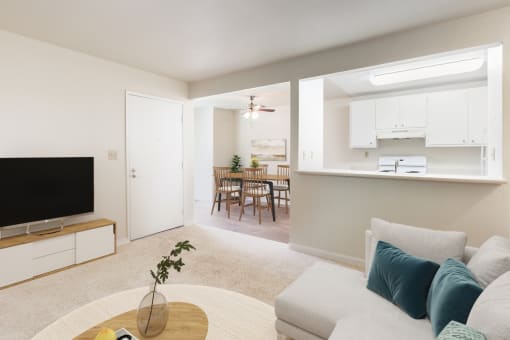 a living room and dining room with a couch and a tv