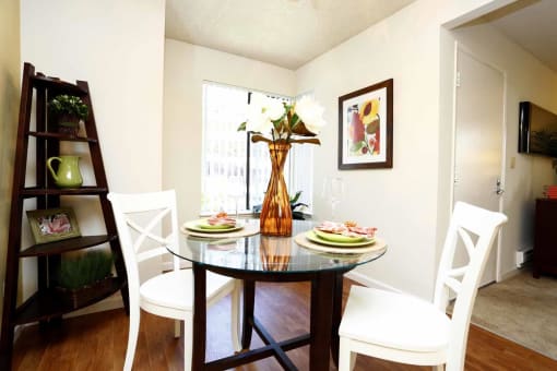 a dining room with a table and chairs