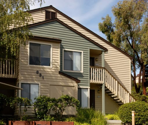 the front of a house with a porch and a staircase