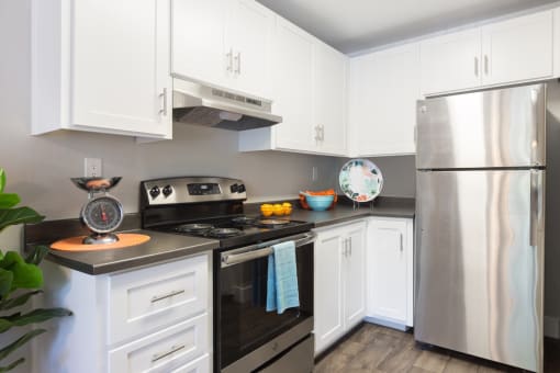 a kitchen with stainless steel appliances and white cabinets