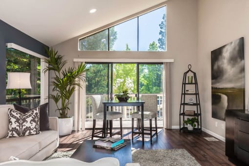 a living room with a couch and a table and a large window