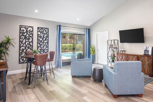a living room with a table and chairs