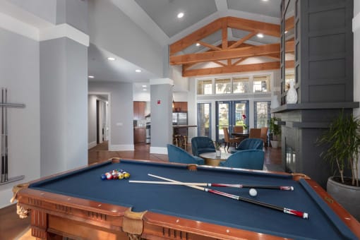 a pool table in a living room with a fireplace